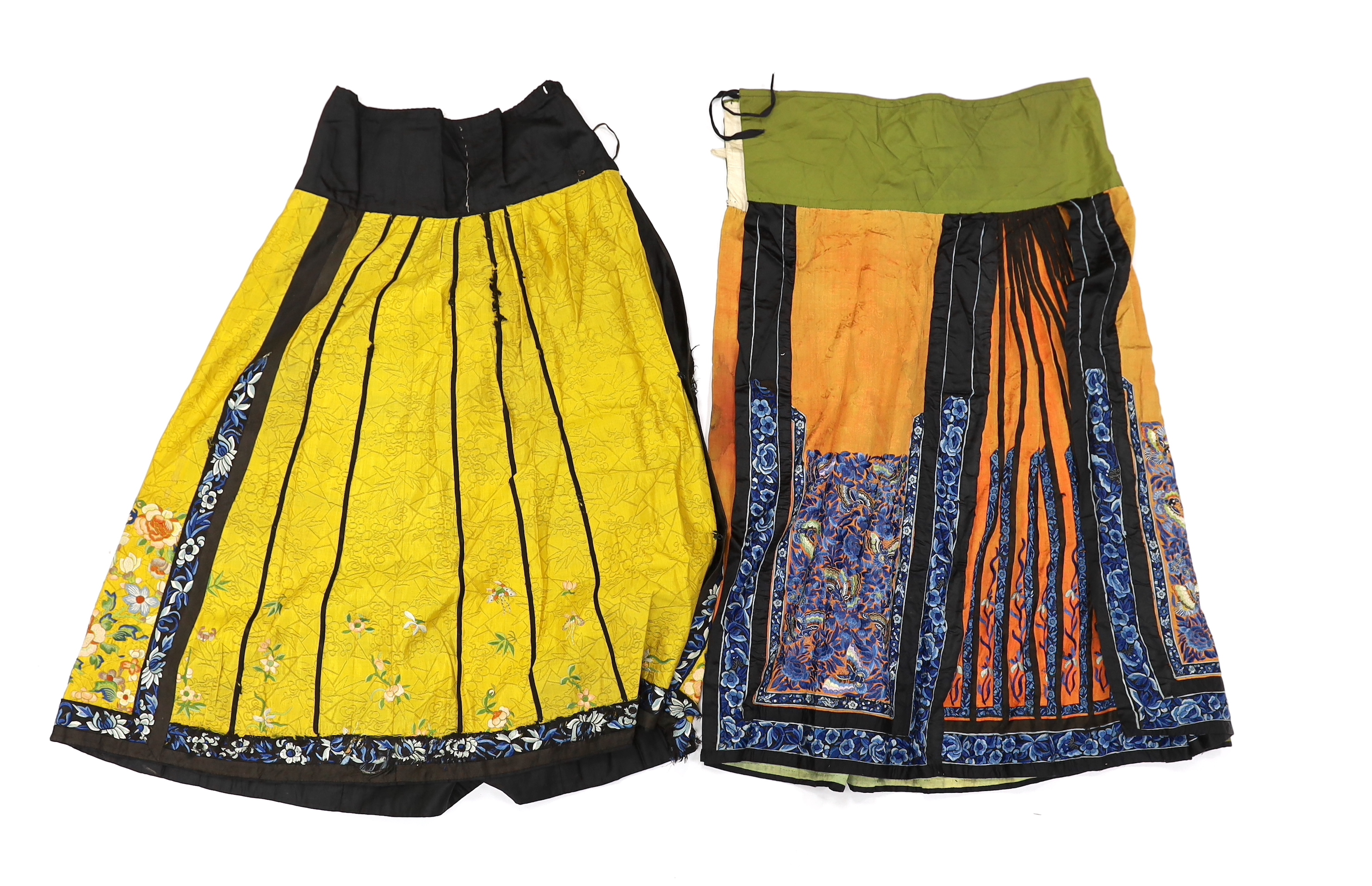 A late Chinese Qing yellow silk damask wedding skirt, with polychrome coloured silk embroidery, together with a similar coral silk damask blue embroidered wedding skirt